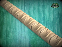 Load image into Gallery viewer, A wooden carving with a curved, wavy design is displayed against a green background.
