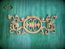 Load image into Gallery viewer, a decorative wooden carving on a green background.
