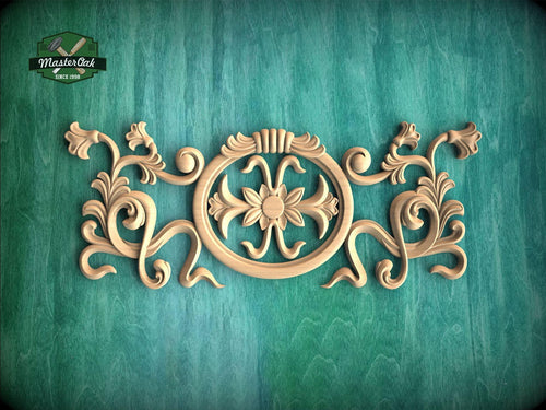 a decorative wooden carving on a green background.