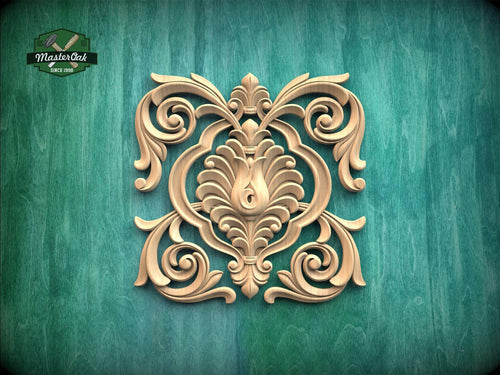an ornate, carved wooden design with intricate scrollwork and floral patterns, set against a green background.