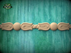 A decorative wooden border with a floral design is displayed against a teal-colored background.