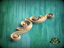 Load image into Gallery viewer, A decorative wooden scrollwork piece is displayed against a green textured background.
