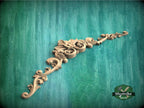 a green wall with a decorative design on it