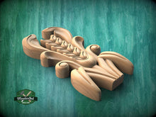 Load image into Gallery viewer, A wooden carving with intricate designs and patterns, displayed against a green background.
