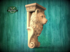 A carved wooden sculpture of a bear's head is displayed against a green background.