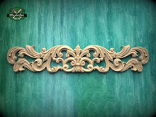 Load image into Gallery viewer, a decorative wooden carving on a green background.
