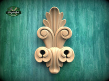 Load image into Gallery viewer, a decorative wooden carving on a green textured background.
