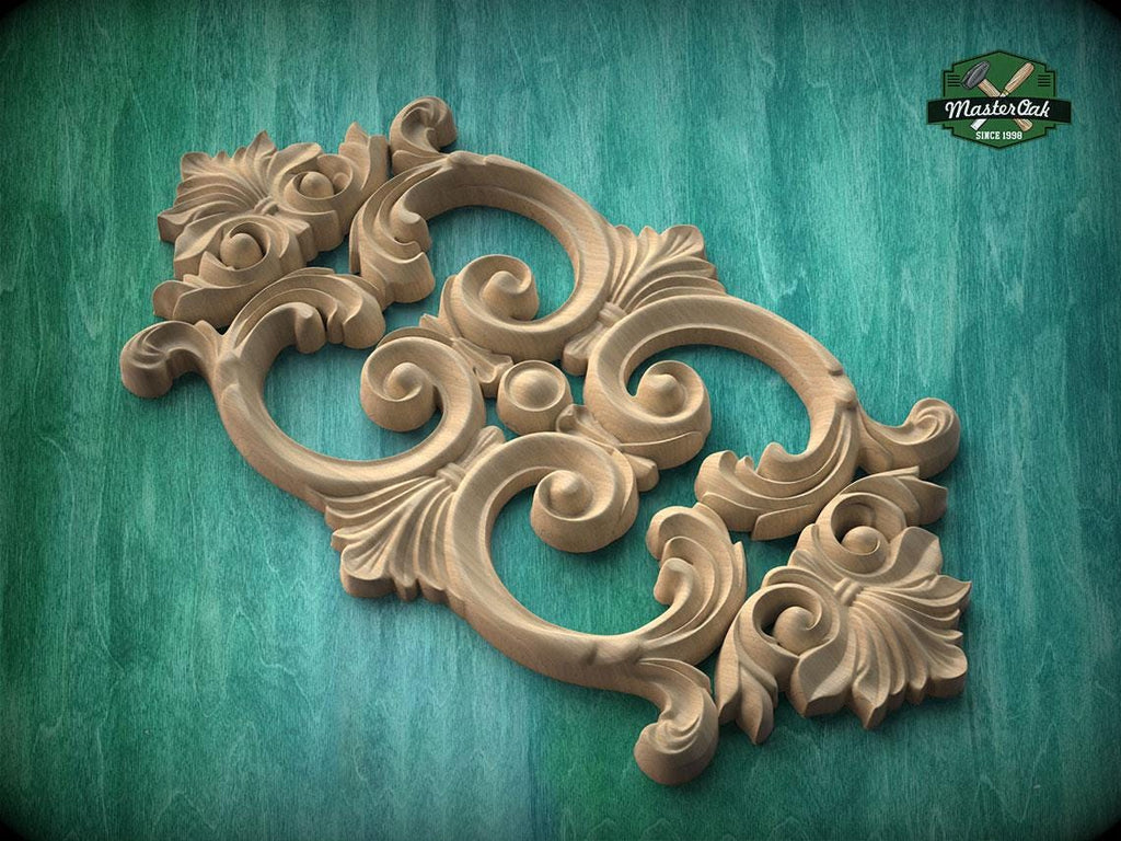 a decorative wooden carving with intricate scrollwork and floral elements, set against a green background.