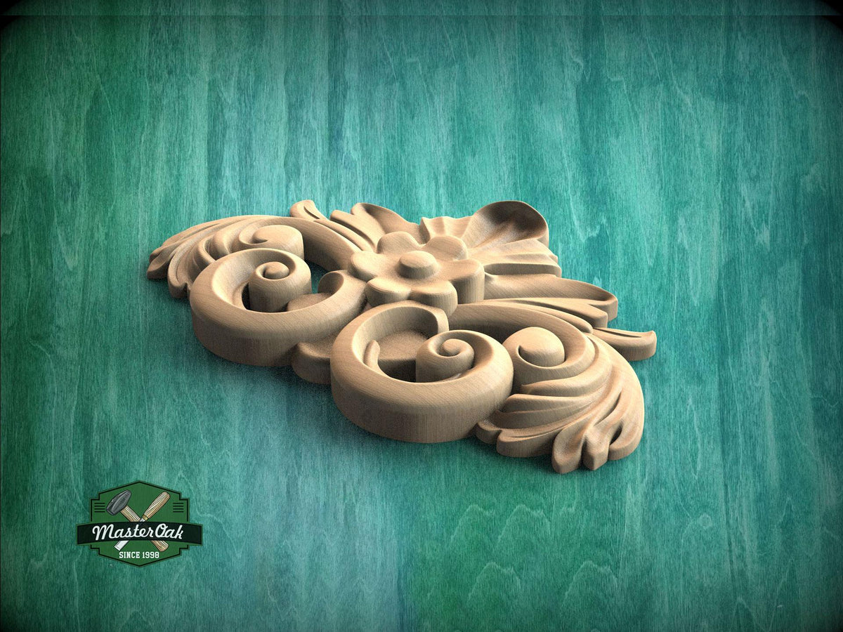 A decorative wooden carving with intricate scrollwork and floral elements is displayed against a green textured background.