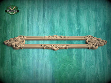 Load image into Gallery viewer, a decorative wooden frame with intricate carvings, displayed against a textured green background.
