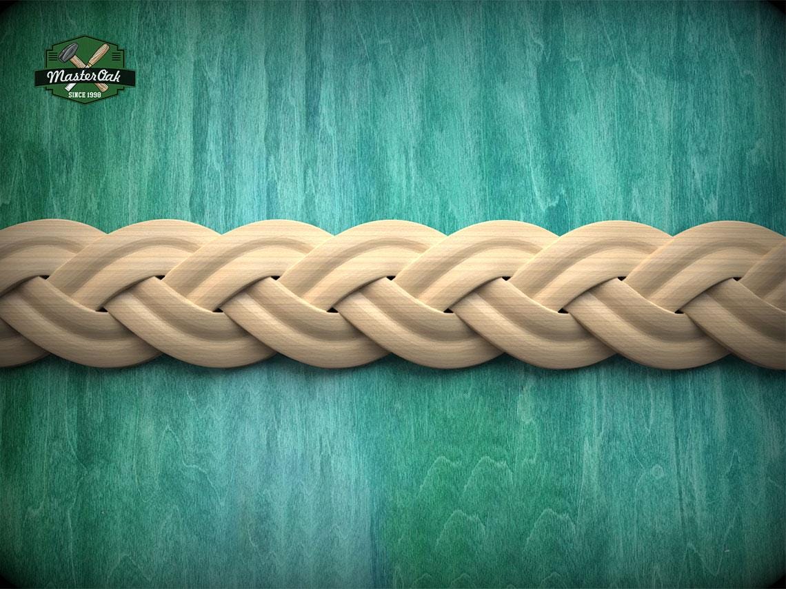 A close-up view of a braided wooden design on a green wooden surface.