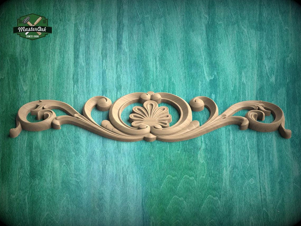 A decorative wooden carving with a floral design is displayed against a teal-colored background.