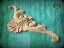 Load image into Gallery viewer, A carved wooden ornament with a floral design, displayed against a green background.
