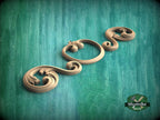 A decorative wooden carving in the shape of a flower is displayed against a green background.