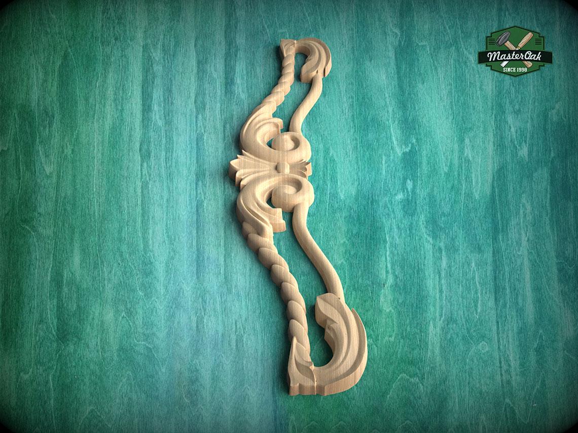 A wooden carving of a decorative piece is displayed against a green textured background.