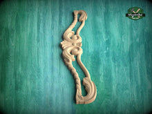 Load image into Gallery viewer, A wooden carving of a decorative piece is displayed against a green textured background.
