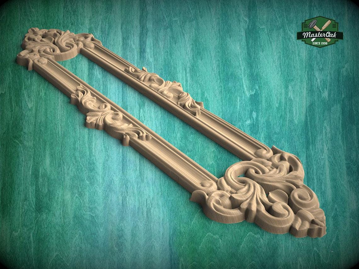 A decorative wooden frame with intricate carvings and patterns, set against a green background.