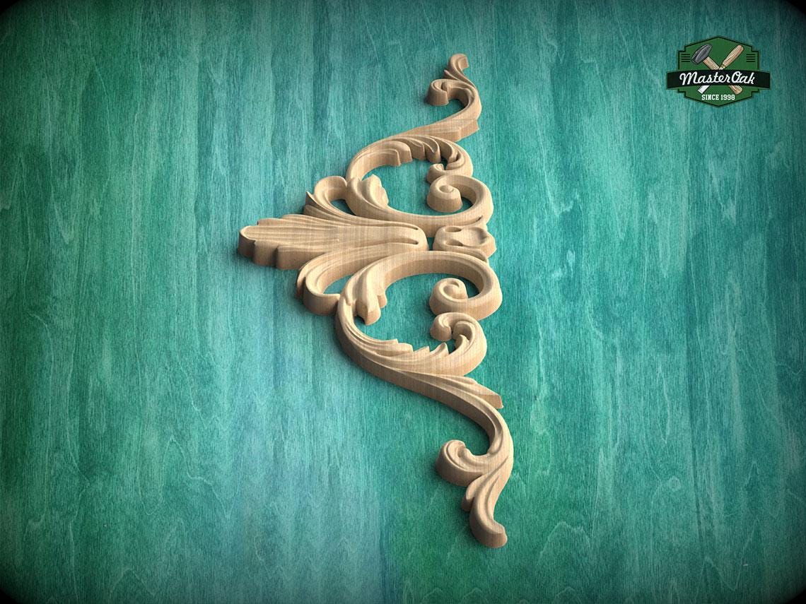A decorative wooden carving in the shape of a flower or scroll is displayed against a green textured background.