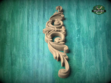 Load image into Gallery viewer, A decorative wooden carving or mold is displayed against a green textured background.
