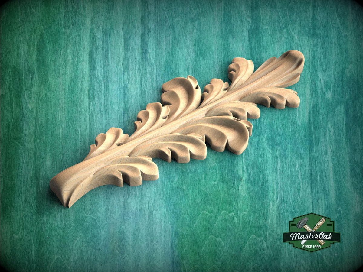 A wooden carving of a leaf-like design is displayed against a green background.