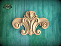 a decorative wooden carving on a green background.