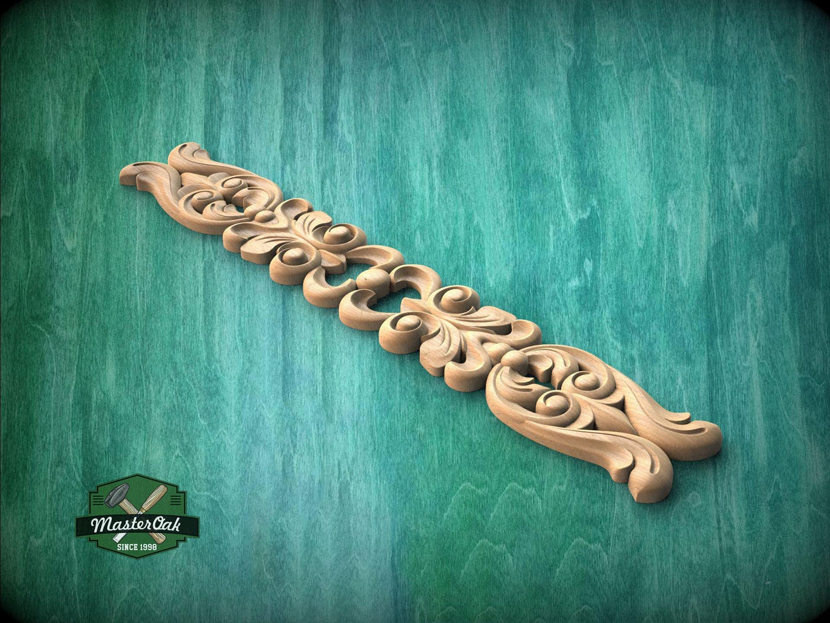 A decorative wooden carving with intricate floral and scroll designs is displayed against a green textured background.