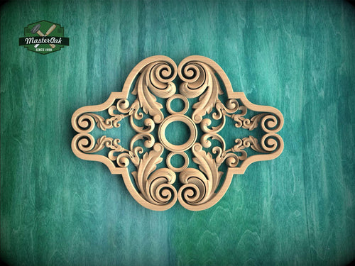 an ornate, intricately carved wooden piece with a floral design, set against a green background.
