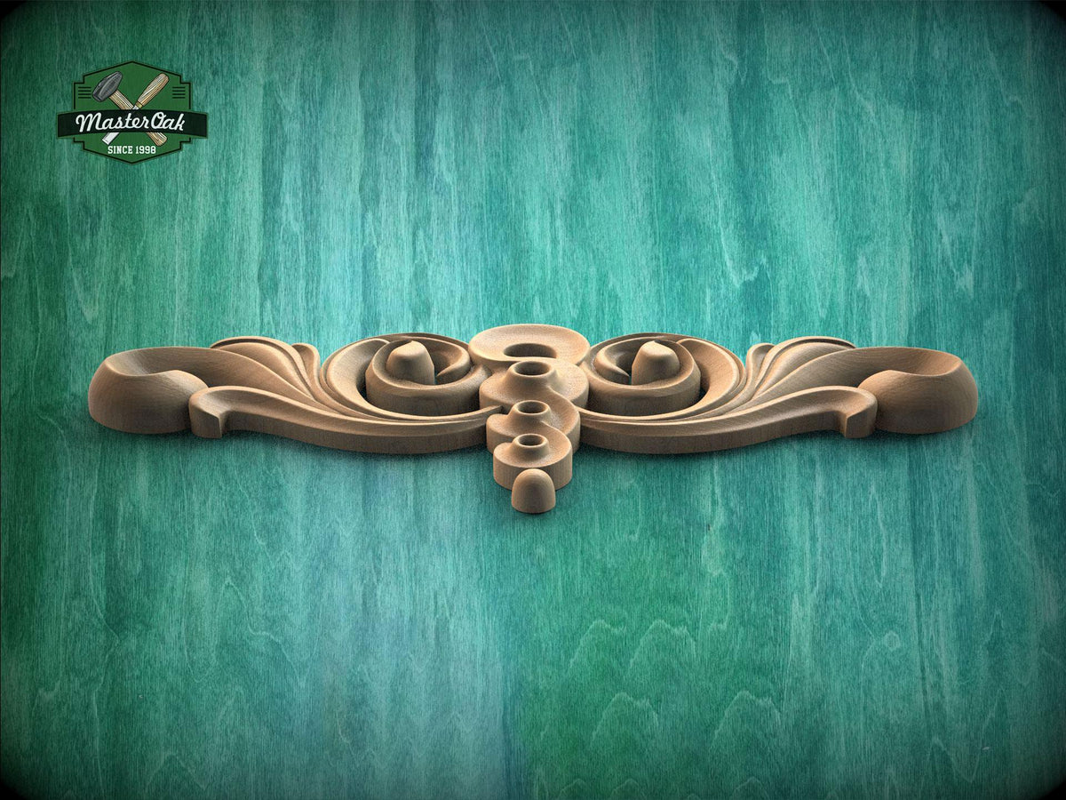 A decorative wooden carving with a floral design is displayed against a teal-colored background.