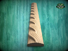 Load image into Gallery viewer, A wooden carving of a curved, wavy design is displayed against a green background.
