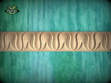Load image into Gallery viewer, a wooden carving with a curved design on a green background.
