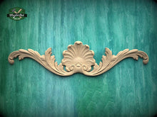 Load image into Gallery viewer, a decorative wooden carving on a green textured background.
