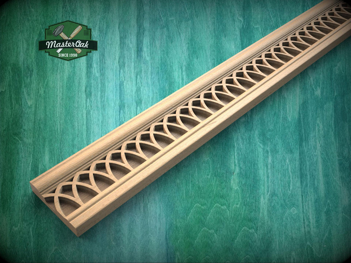 Carved wooden gothic molding with repeating pointed arch pattern, shown as decorative trim for cabinets, furniture, or wall panels.