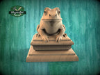A wooden frog statue sitting on a wooden pedestal against a green background.