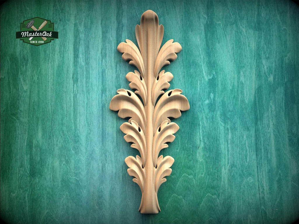 a decorative wooden leaf-like object with a vertical, ornate design on a green background.