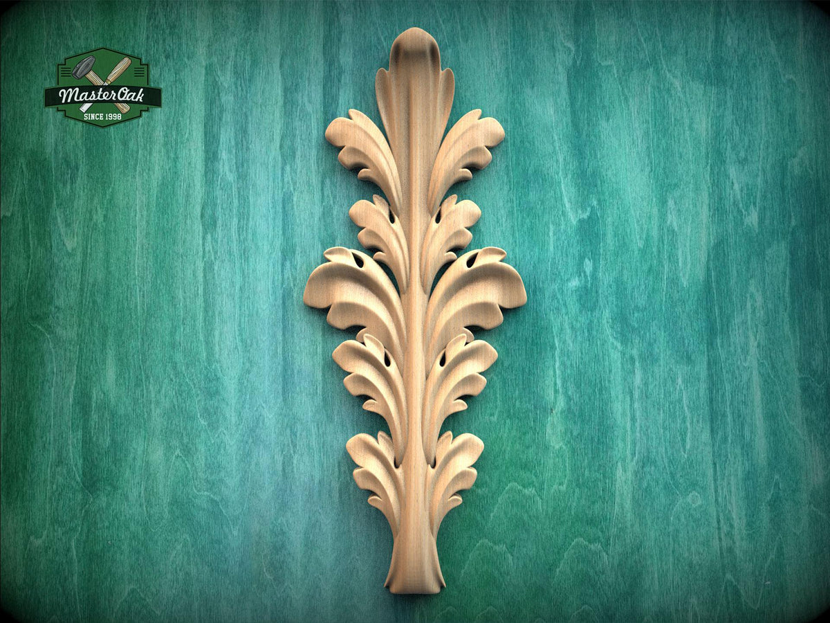 a decorative wooden leaf-like object with a vertical, ornate design on a green background.