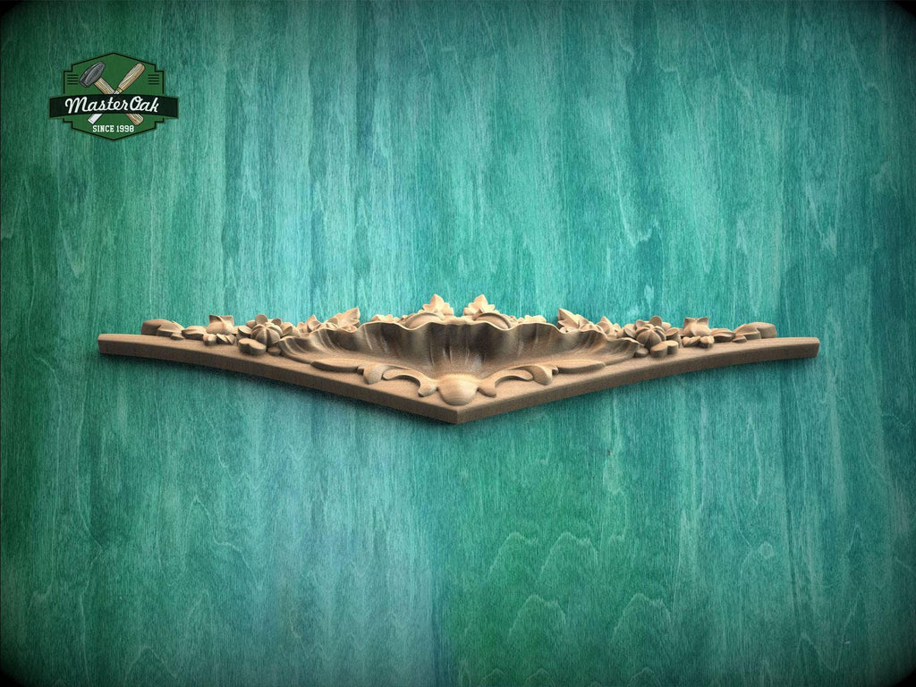 A decorative wooden panel with intricate floral designs is displayed against a textured green background.