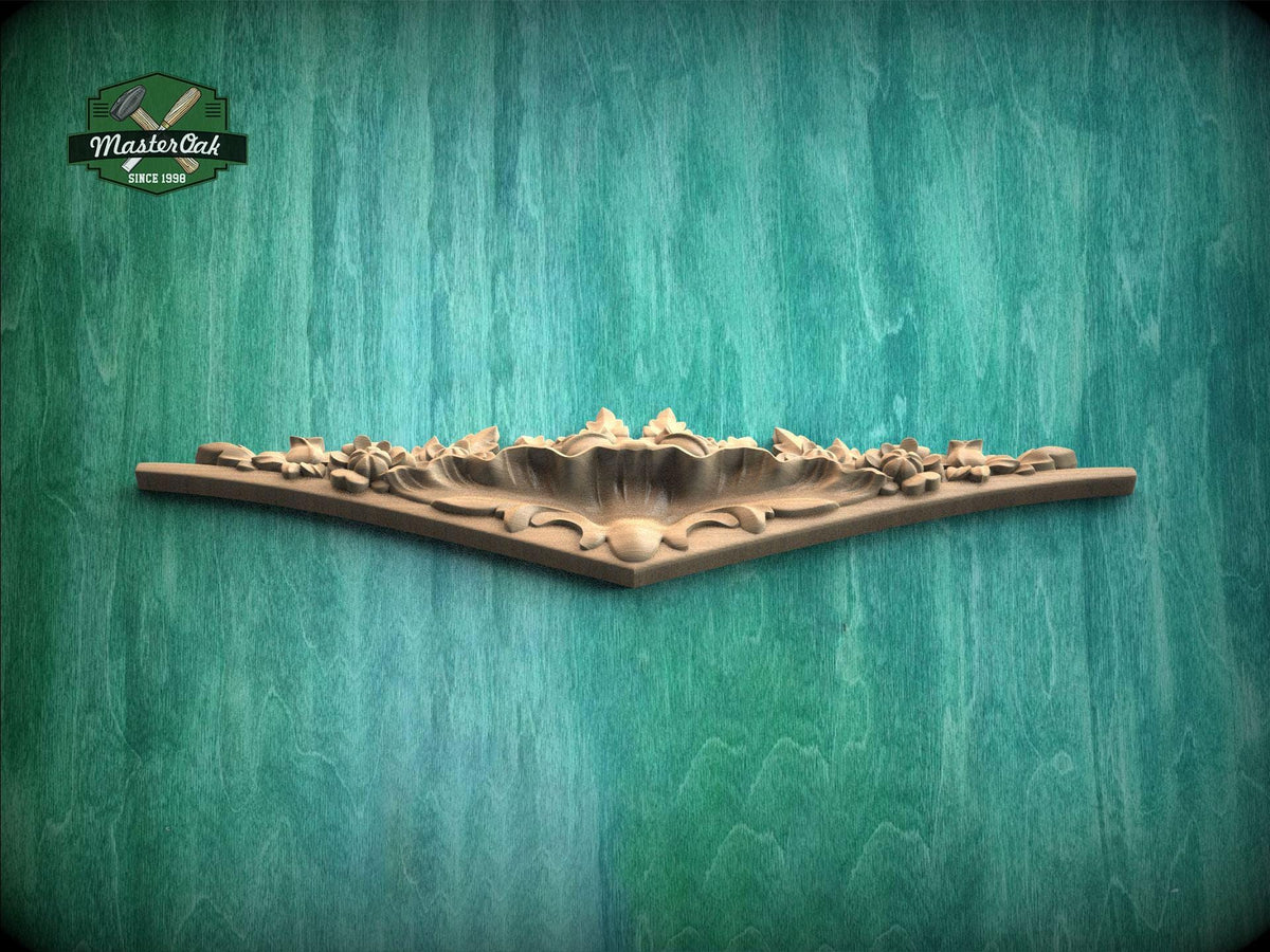 A decorative wooden panel with intricate floral designs is displayed against a textured green background.