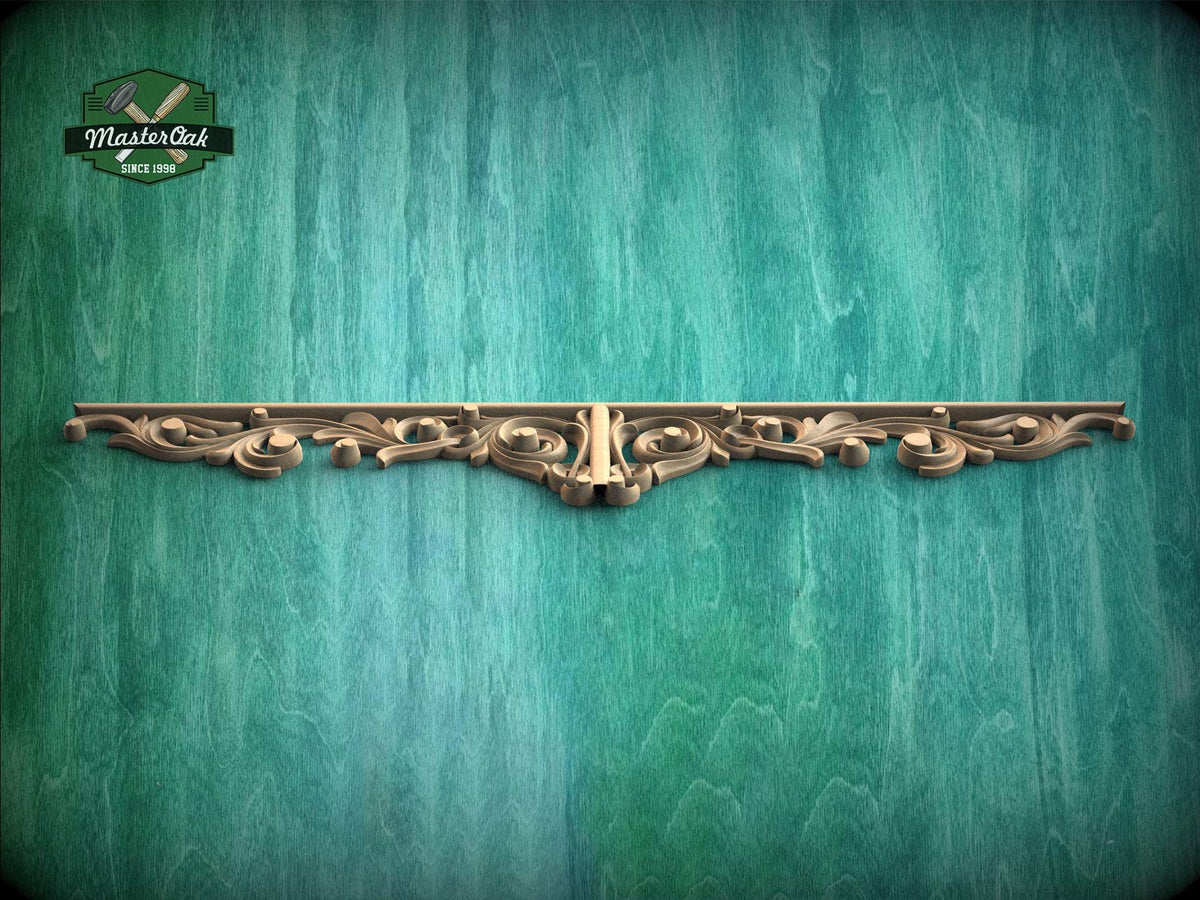 A decorative wooden molding or panel with an ornate, carved design is displayed against a textured green background.