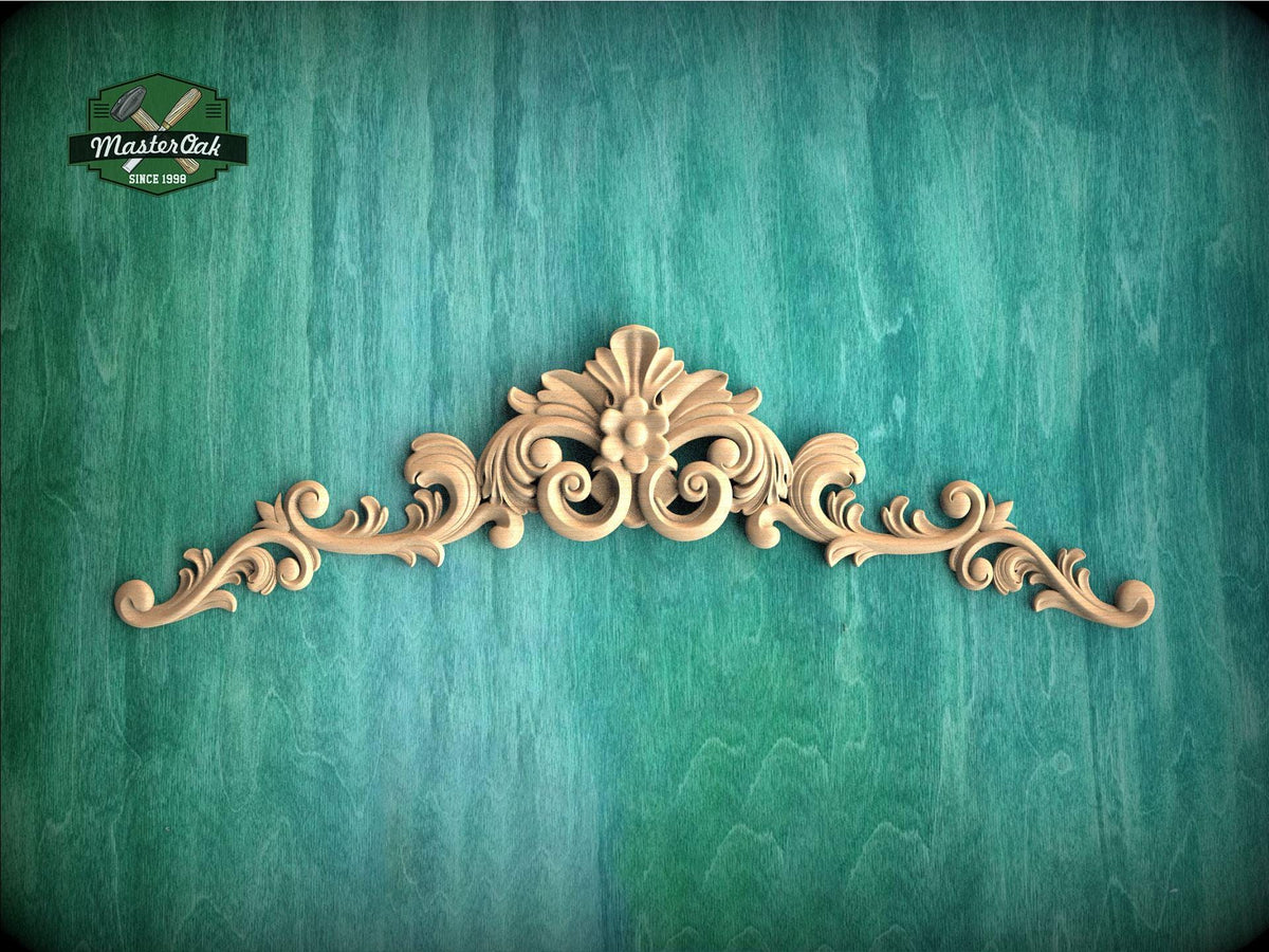a green wall with a wooden carving on it