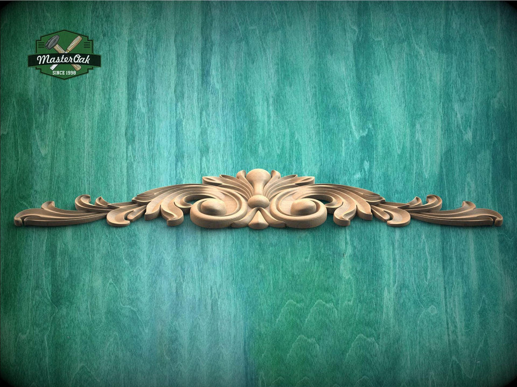a green wall with a wooden carving on it