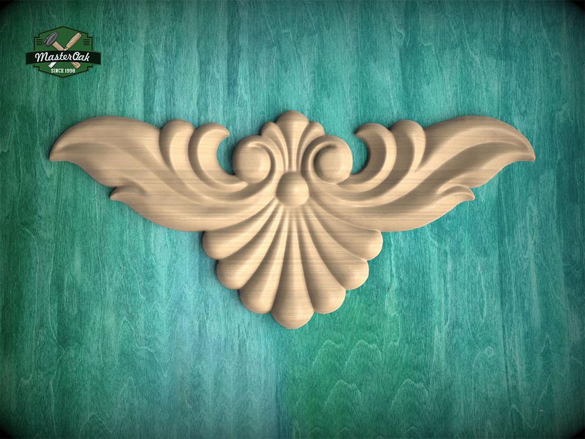 a decorative wooden carving of a stylized bird or wing-like shape, set against a teal-colored background.