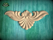 Load image into Gallery viewer, a decorative wooden carving of a stylized bird or wing-like shape, set against a teal-colored background.
