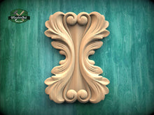 Load image into Gallery viewer, a carved wooden piece with an intricate, symmetrical design, displayed against a green background.
