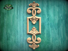 Load image into Gallery viewer, a decorative wooden frame with intricate floral designs, set against a green textured background.
