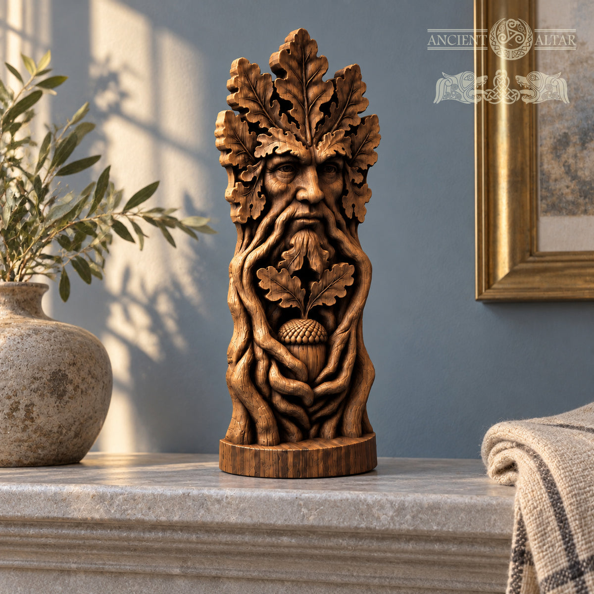 A wooden sculpture of a face with a leafy beard and an acorn in its mouth, placed on a marble surface.