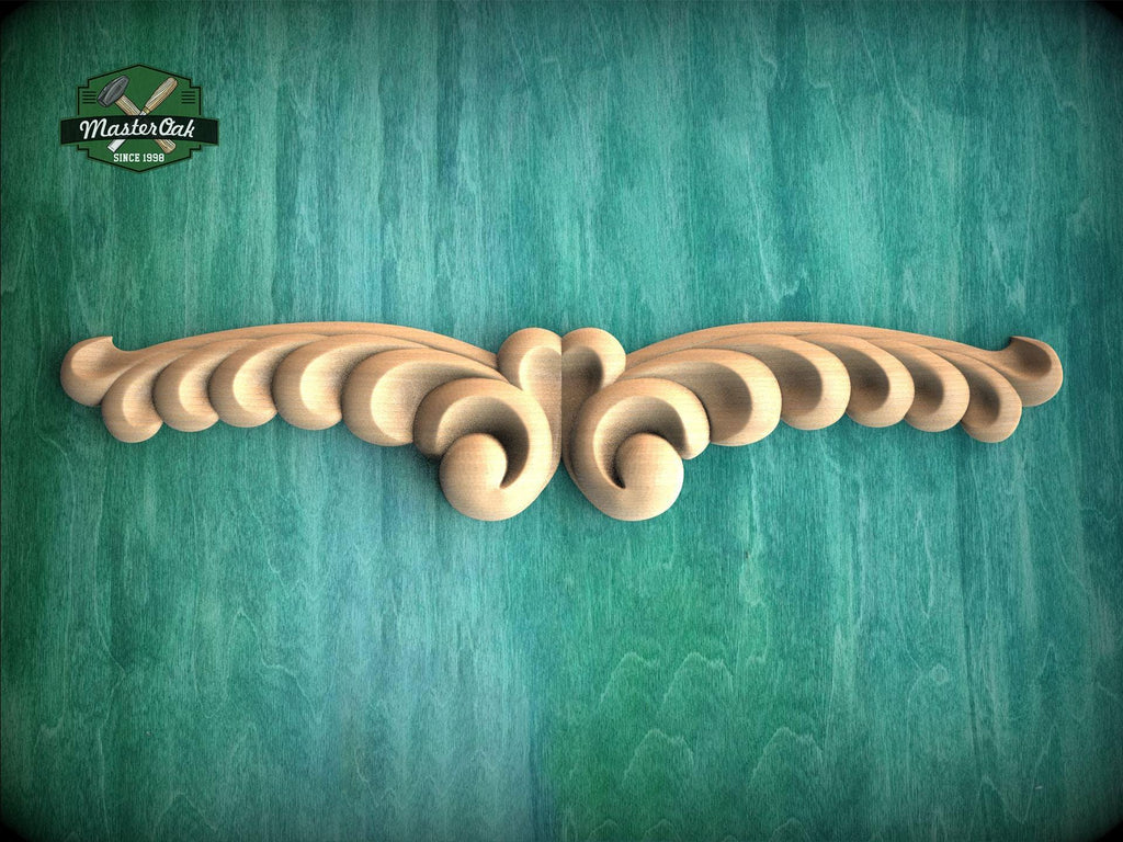 A decorative wooden carving with a floral pattern is displayed against a teal-colored background.