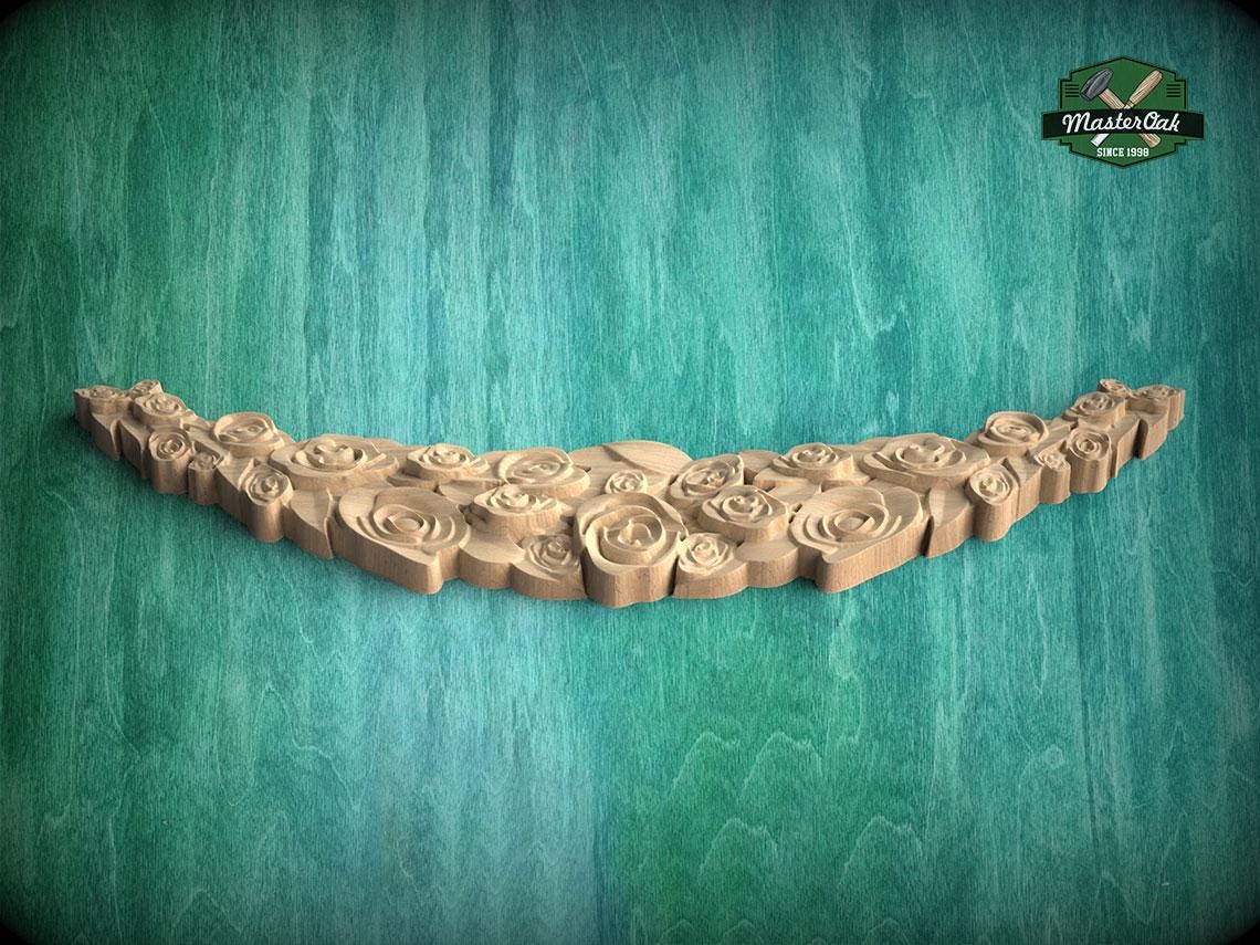 A wooden carving of a flower-like design is displayed against a green background.