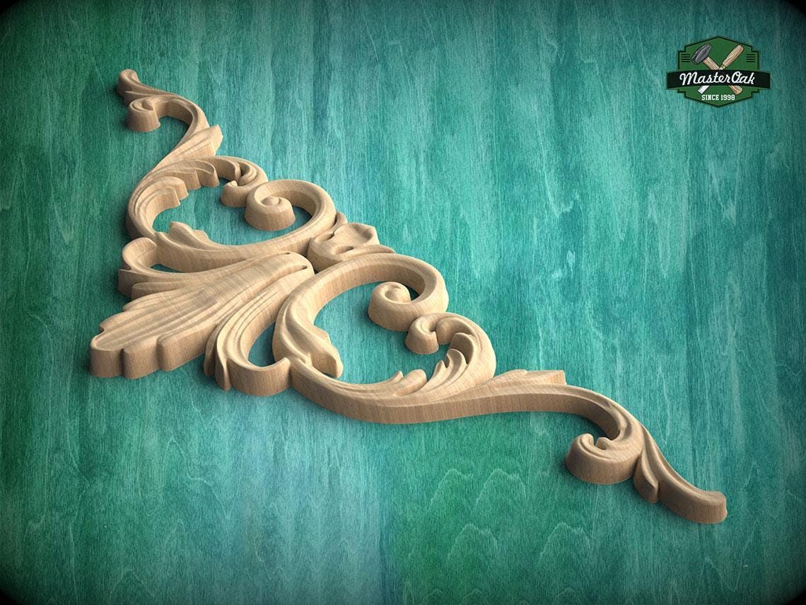 A decorative wooden carving with intricate scrollwork is displayed against a green background.