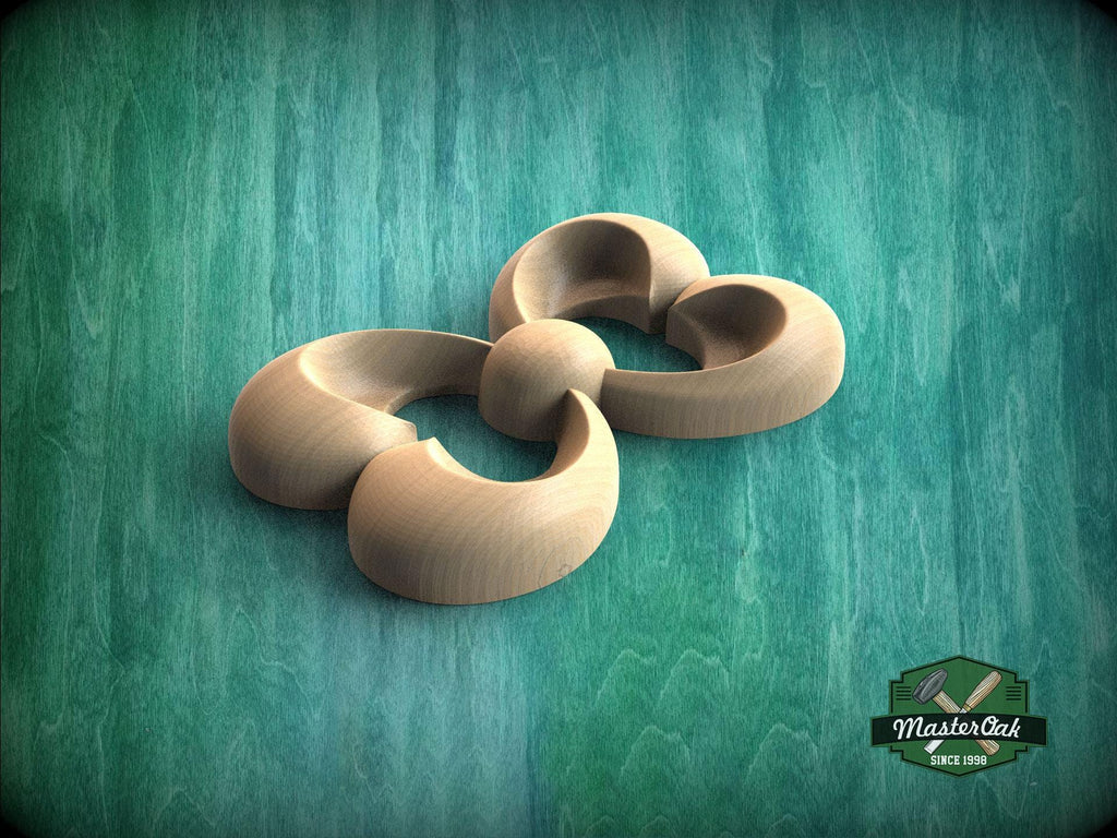 A wooden sculpture in the shape of a flower, with curved petals and a round center, is displayed against a green background.