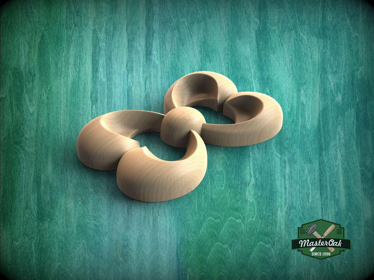 A wooden sculpture in the shape of a flower, with curved petals and a round center, is displayed against a green background.